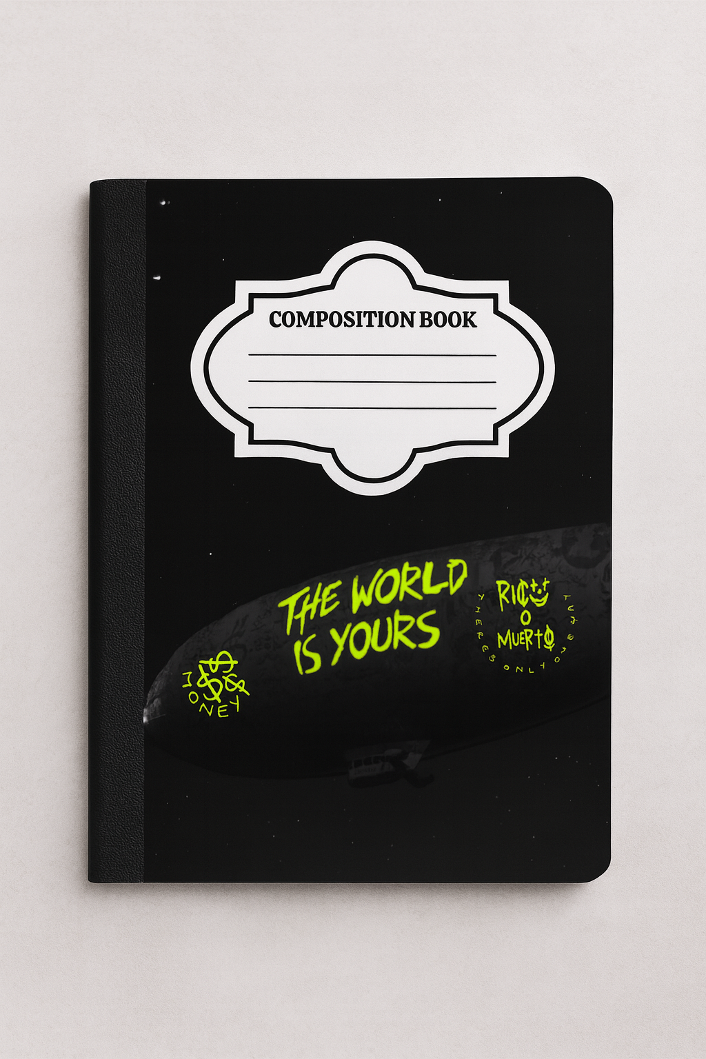 Composition notebook with black sky and neon green graffiti-style blimp that says 'The World Is Yours' — edgy back-to-school journal