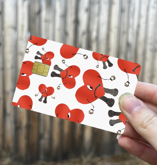Bad Bunny inspired credit card skin with repeating sad red heart character design, white background, and chip cutout
