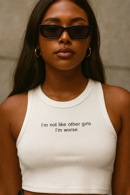 Woman wearing a white ribbed crop tank top with black text that reads “I’m not like other girls, I’m worse”