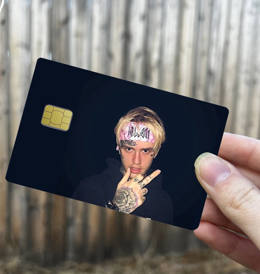 Credit card-sized cover featuring emo rap inspired design with tattooed blonde artist wearing “Hellboy” pink headband, on black background
