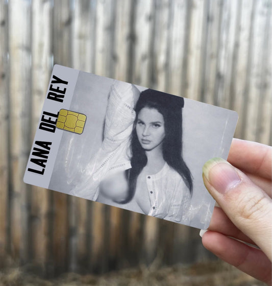 Lana Del Rey credit card skin featuring grayscale portrait with bold vertical name text and chip cutout design
